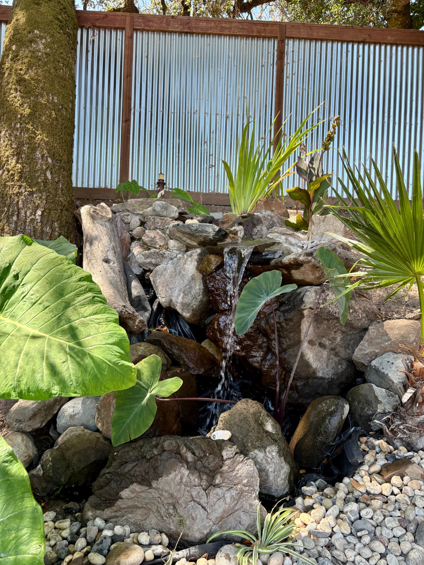 Water spilling over stacked stone into the pondless basin