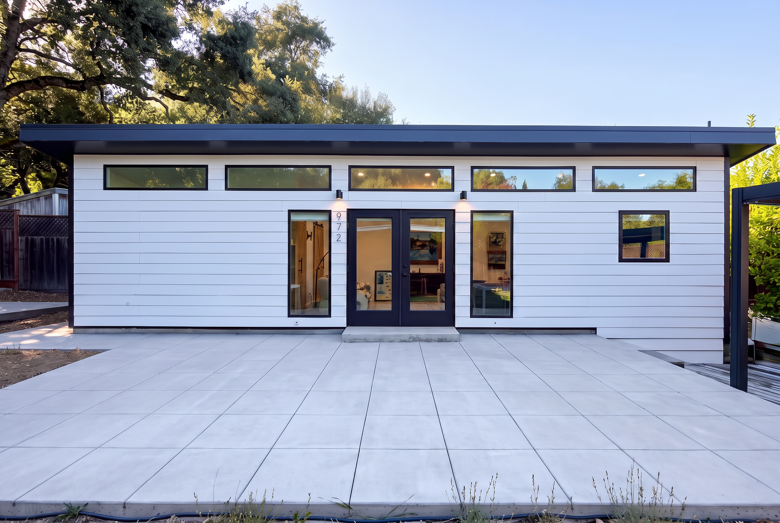 Exterior of the newly built ADU at 970 Glenwood Drive with white siding, black trim, and clerestory windows