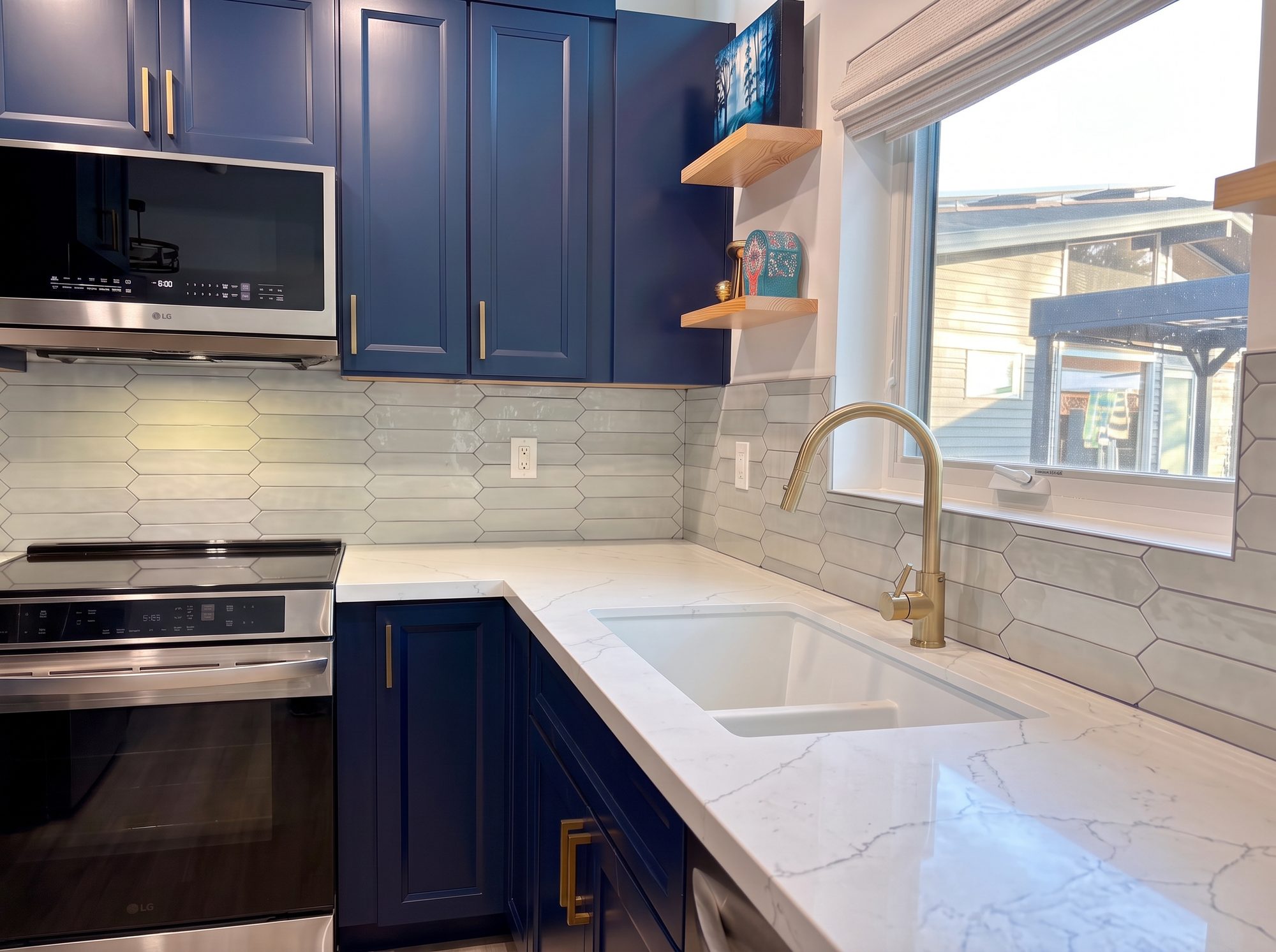 ADU kitchen detail with induction range, tile backsplash, and quartz counters