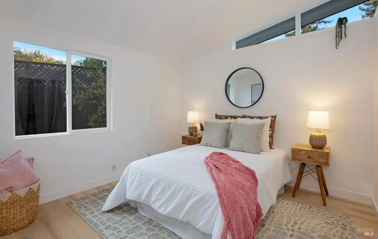 Third bedroom with clerestory windows and light oak floors
