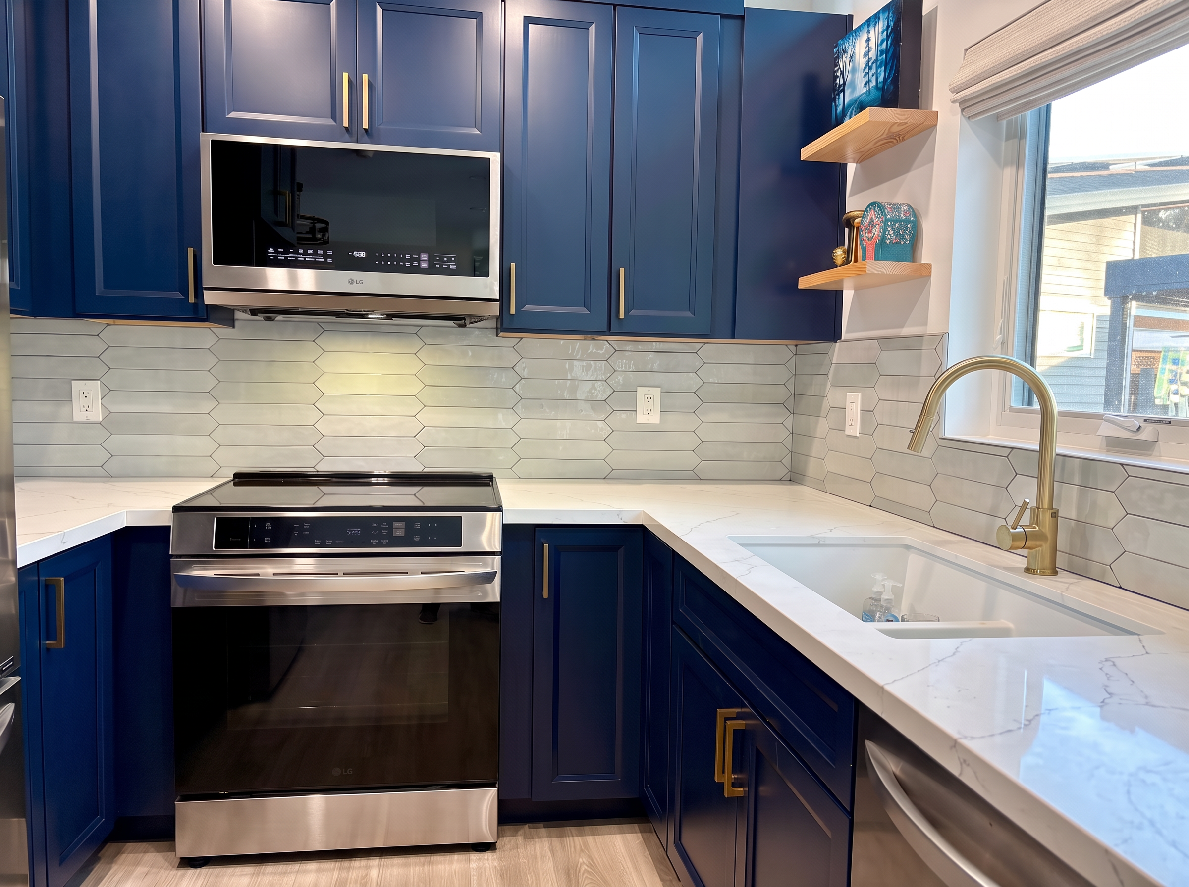 ADU kitchen detail with induction range, tile backsplash, and quartz counters