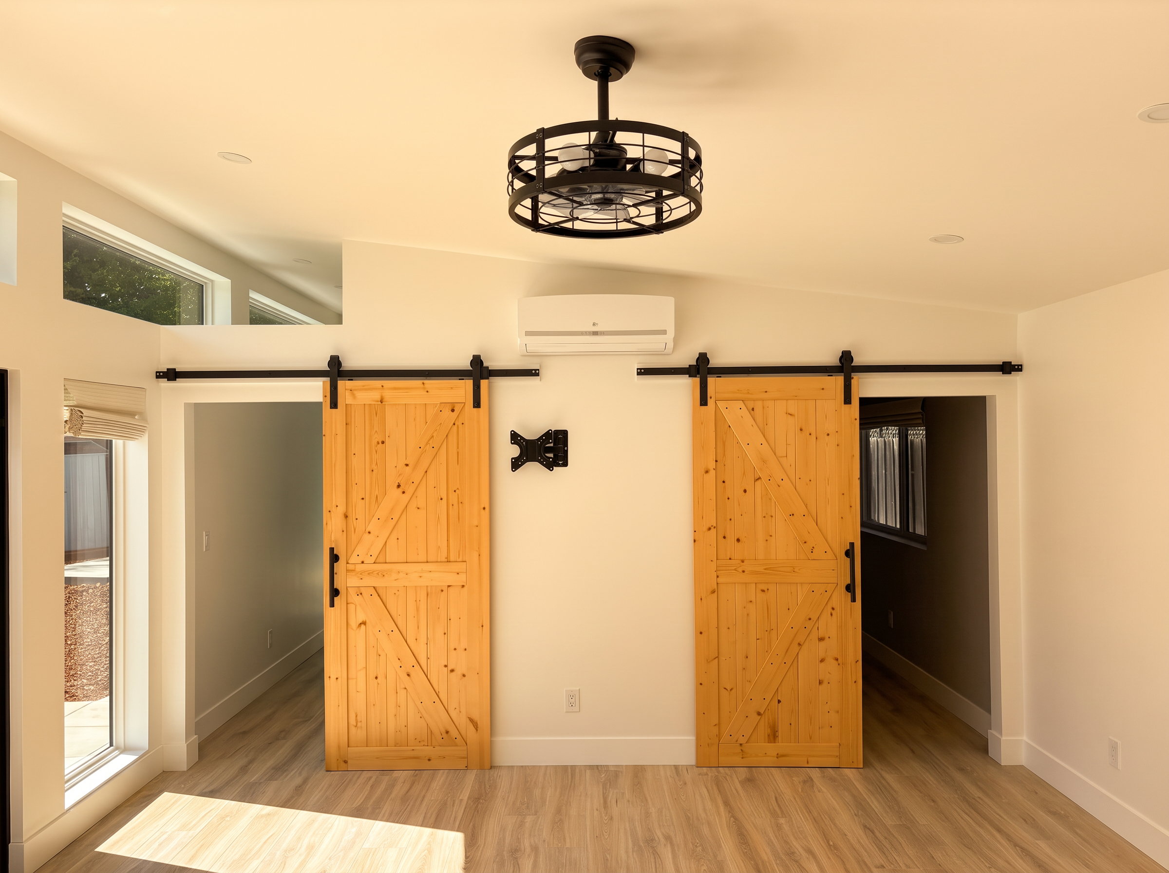 Twin pine barn doors and caged ceiling fan in the ADU