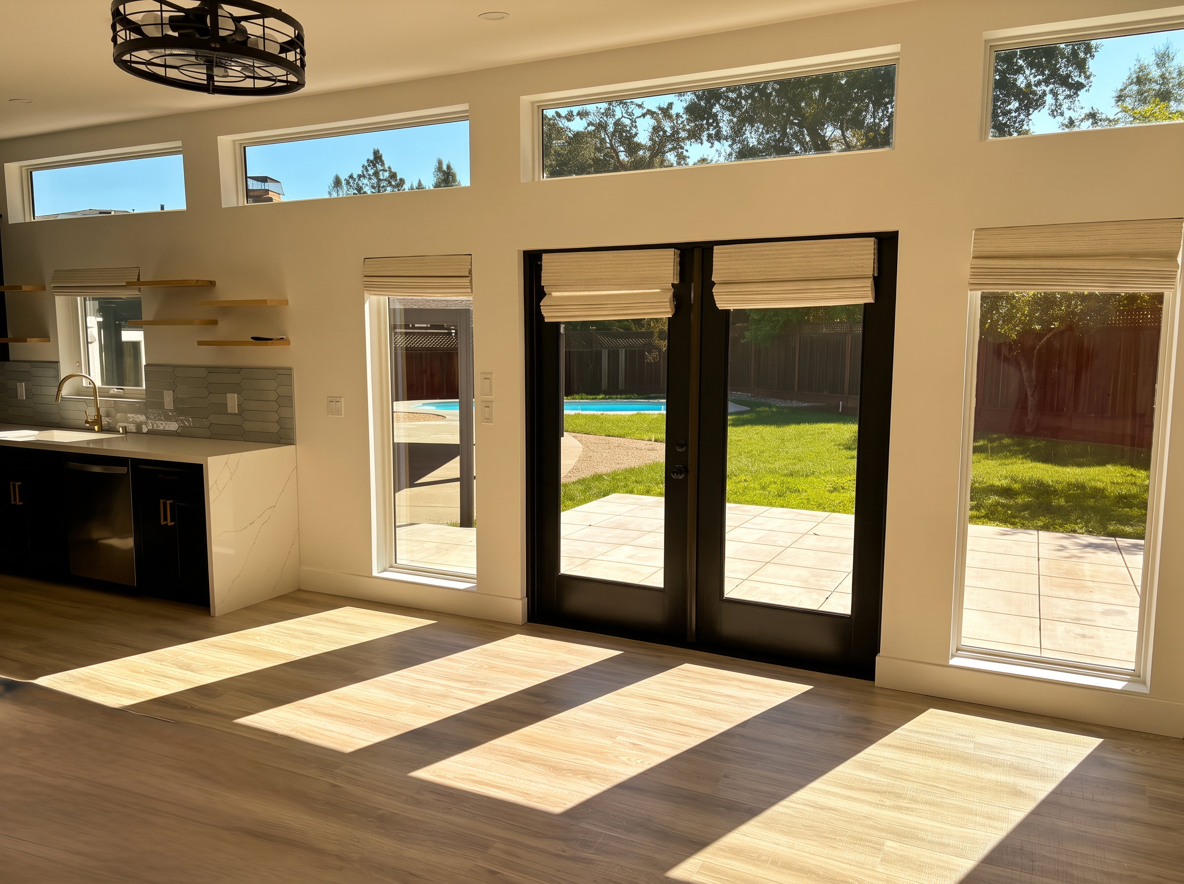 ADU kitchenette and glass doors opening to the pool and lawn