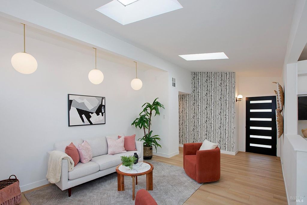 Wide view of the open-beam living and dining space